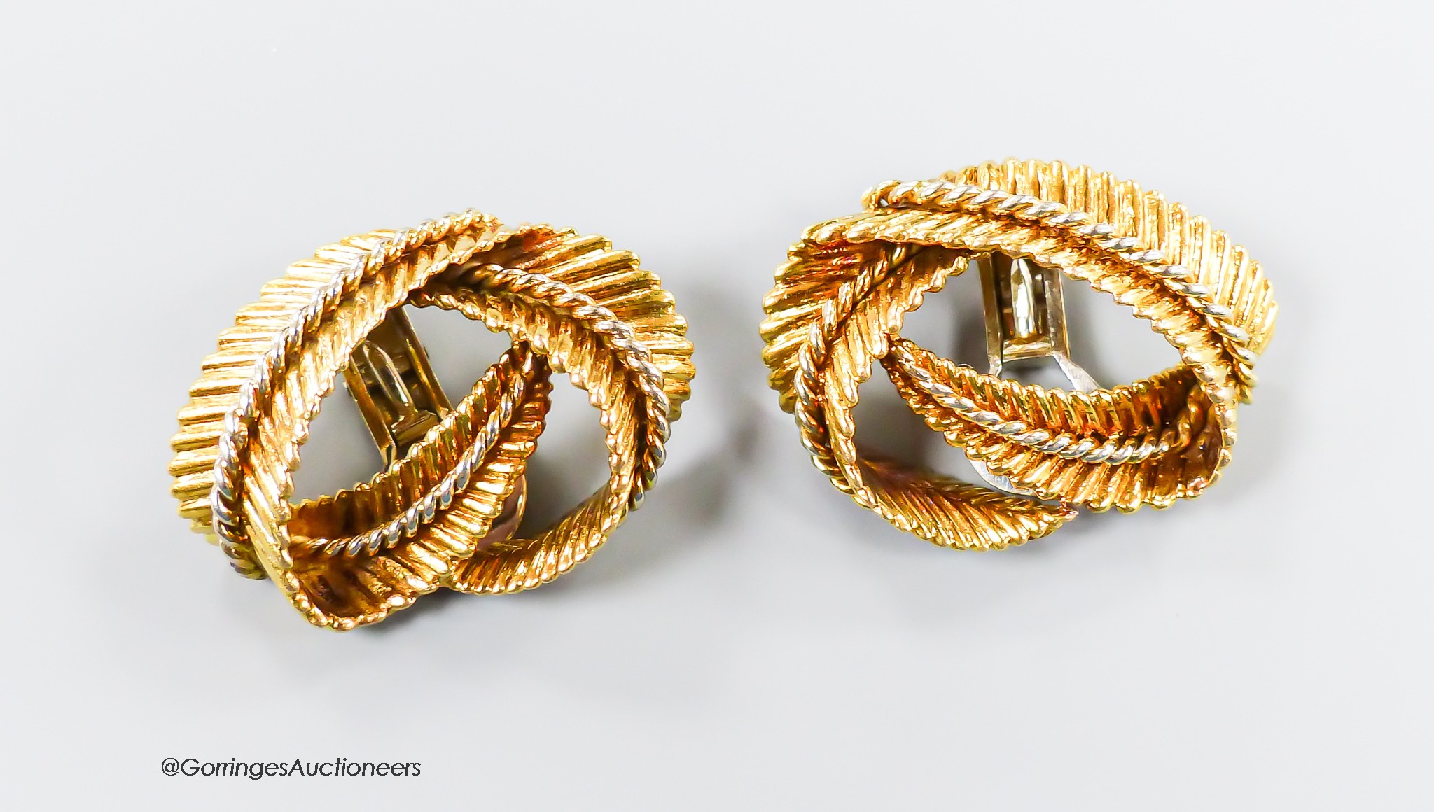 A pair of textured 750 yellow metal 'fern knot' ear clips, 27mm, 16.8 grams.